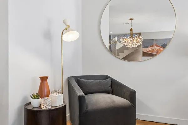 a living room with furniture and chandelier
