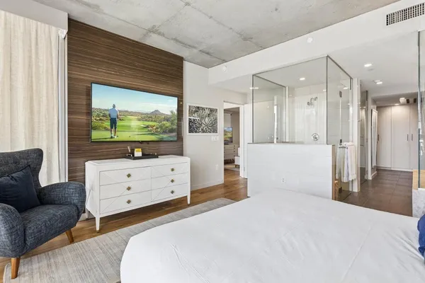 a bedroom with a bed and a flat screen tv