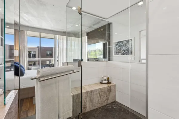 a bathroom with a tub sink and mirror