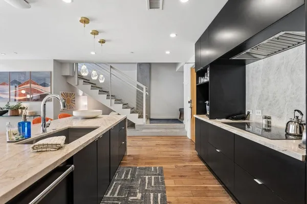a kitchen with counter top space a sink stainless steel appliances and cabinets
