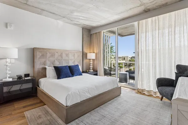 a large bedroom with a bed and large window