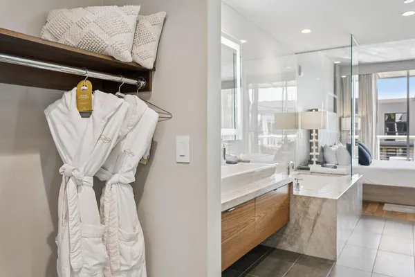 a bathroom with a sink mirror and tub