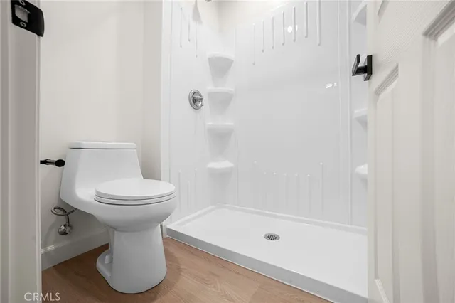 a bathroom with a toilet sink and shower
