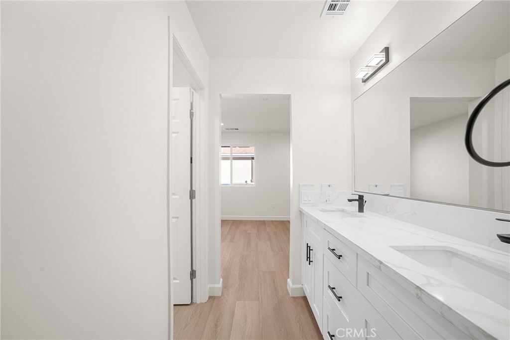 900 South Hert Street Colton, CA 92324 - Photo 14 of 26 a spacious bathroom with a double vanity sink and a mirror