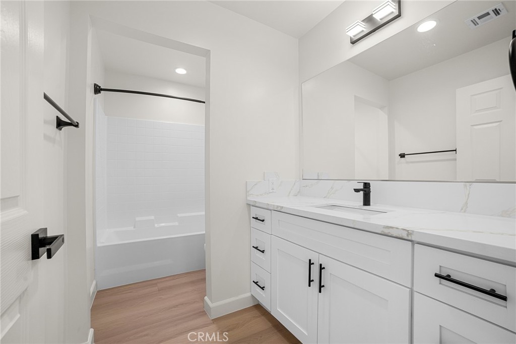 900 South Hert Street Colton, CA 92324 - Photo 19 of 26 a bathroom with a shower sink and mirror