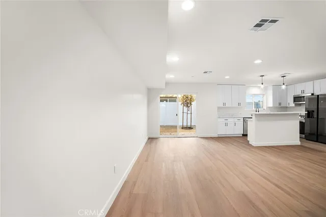 a view of a kitchen with a sink and cabinets