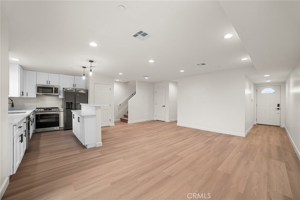 900 South Hert Street Colton, CA 92324 - Photo 5 of 26 a view of kitchen with cabinets and wooden floor