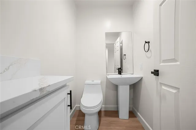 a bathroom with a sink a toilet and mirror