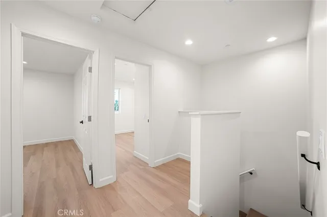 a view of a hallway with wooden floor