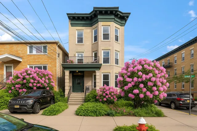 a front view of building with flowers