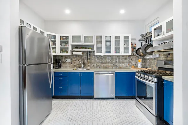 a kitchen with stainless steel appliances granite countertop a refrigerator and a stove