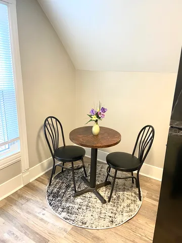 a dining room with furniture and wooden floor