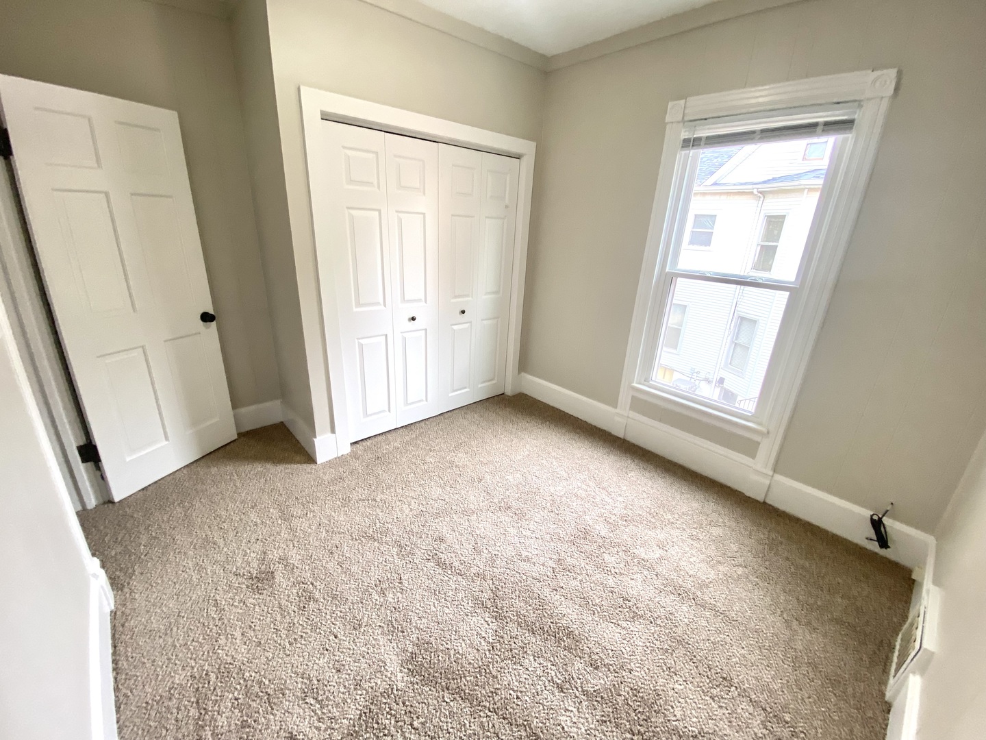 612 1/2 East Chestnut Street, Unit 2 Bloomington, IL 61701 - Photo 7 of 8 an empty room with windows