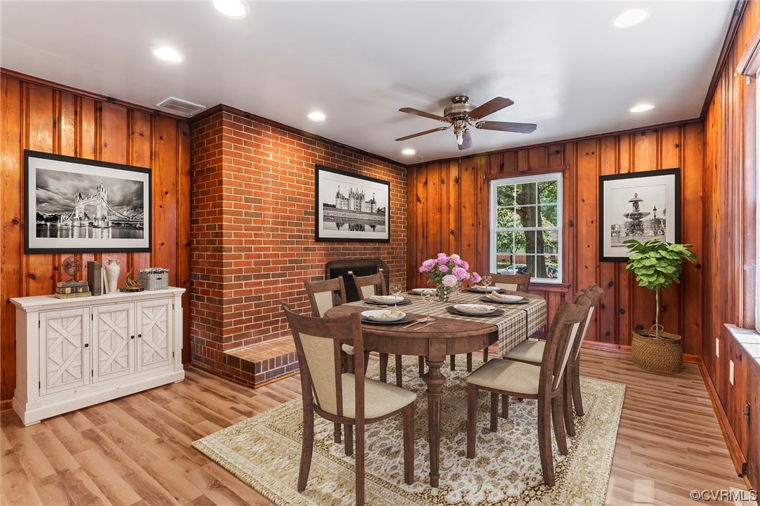 5512 Raleigh Road Henrico, VA 23231 - Photo 3 of 26 Dining space featuring light hardwood flooring, wooden walls, brick wall, and ceiling fan