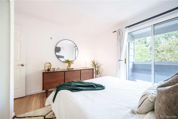 a bedroom with a bed and a large window