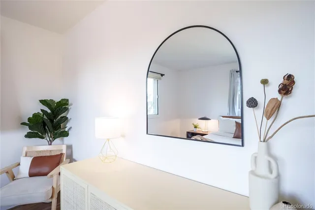 a bedroom with a bed and a potted plant