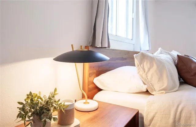 a bedroom with a bed and a table