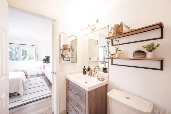 a bathroom with a sink a toilet and a mirror