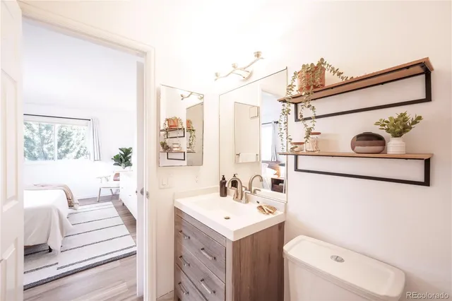 a bathroom with a sink a toilet and a mirror