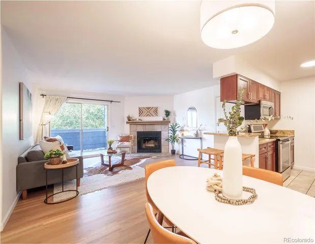 a living room with fireplace furniture and a large window