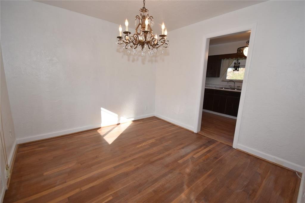 575 Kelso Road Pittsburgh, PA 15243 - Photo 5 of 24 Dining room complete with a period specific chandelier, refinished hardwood flooring and ample space for a table.