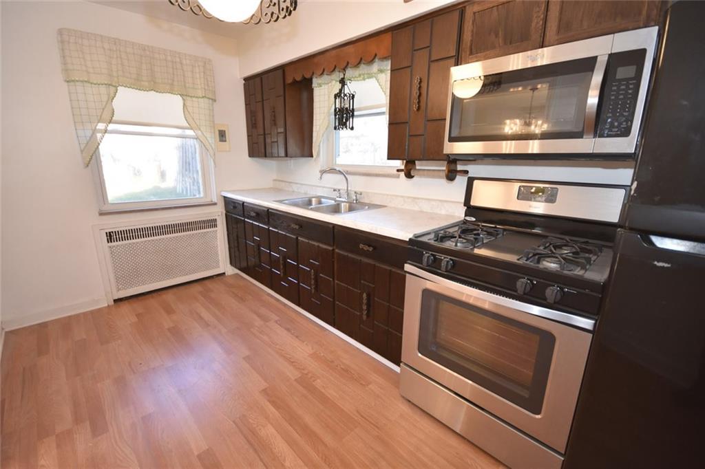 575 Kelso Road Pittsburgh, PA 15243 - Photo 7 of 24 Impressive! Let's get cooking! A brand new microwave and additional cabinetry, newer refrigerator and stove are all included. There is even enough room for a small table if you wish. New flooring as well.