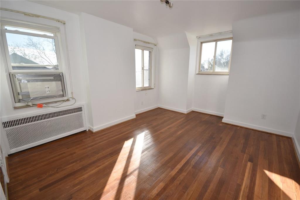 575 Kelso Road Pittsburgh, PA 15243 - Photo 9 of 24 One of the two bedrooms. Lots of natural lighting, a closet and refinished hardwood floors. The window a/c unit is included (as-is).