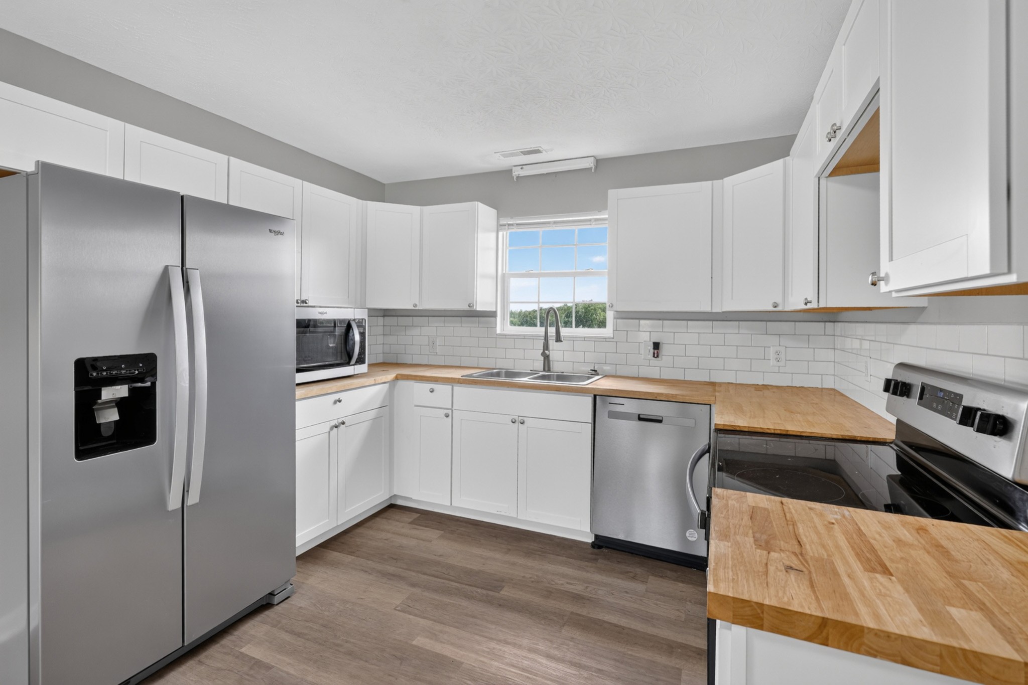 120 Driver Road Lafayette, TN 37083 - Photo 11 of 39 a kitchen with stainless steel appliances granite countertop a refrigerator sink and stove