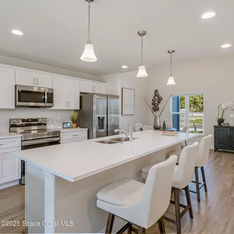 a large kitchen with a table and chairs
