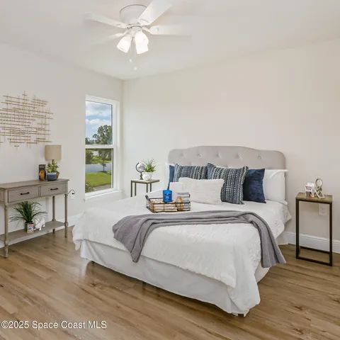 a bedroom with bed and a chandelier