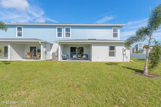 a view of a house with pool and a yard