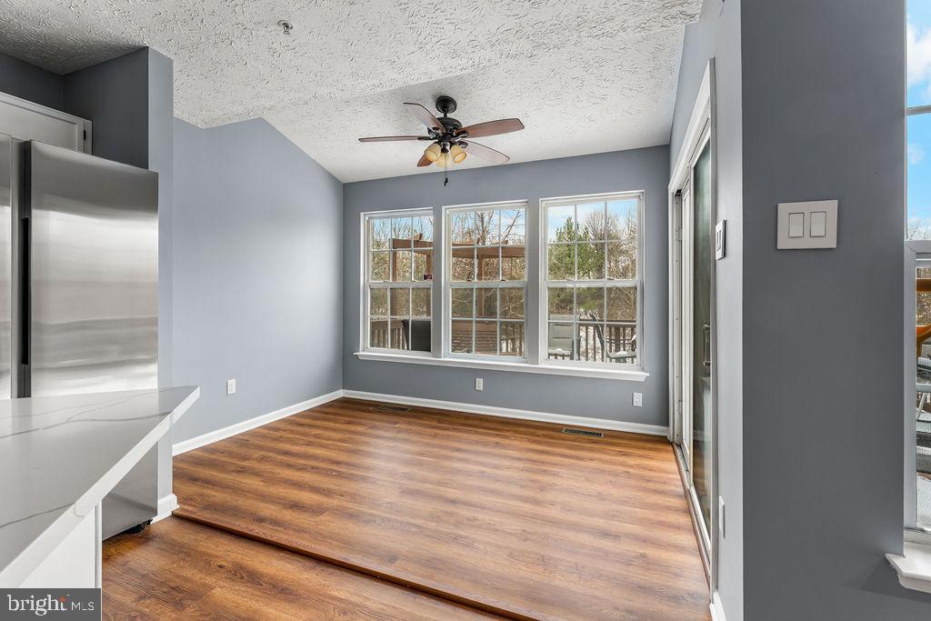 7711 Cornerstone Way Baltimore, MD 21244 - Photo 12 of 33 a view of an empty room with wooden floor and a window