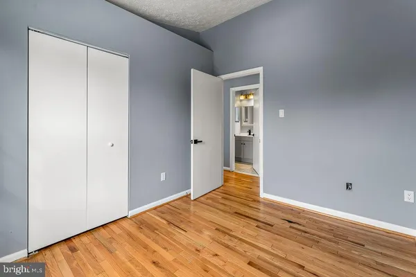 a view of empty room with wooden floor