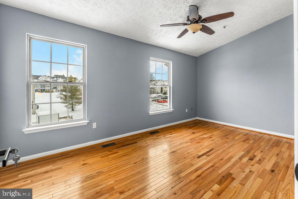 7711 Cornerstone Way Baltimore, MD 21244 - Photo 21 of 33 a view of empty room with wooden floor and fan