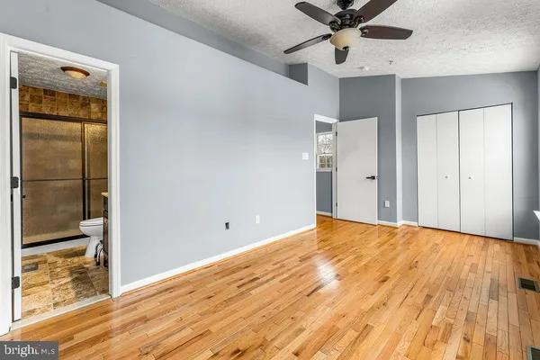 a view of a room with a ceiling fan