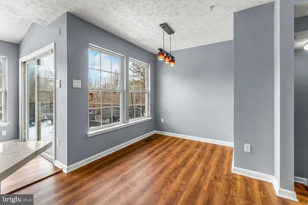 a view of an empty room with glass door and balcony