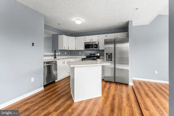 a kitchen with a refrigerator a stove top oven a sink and dishwasher