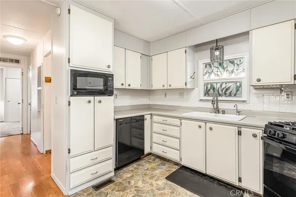 a kitchen with stainless steel appliances a stove a table and chairs