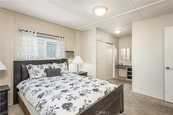a bedroom with a bed and a window