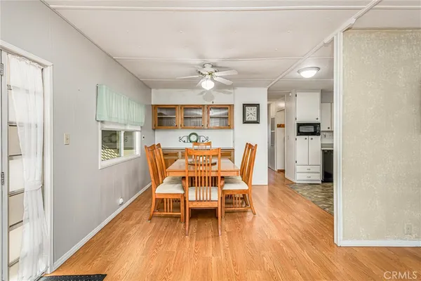 a dining room with furniture and wooden floor