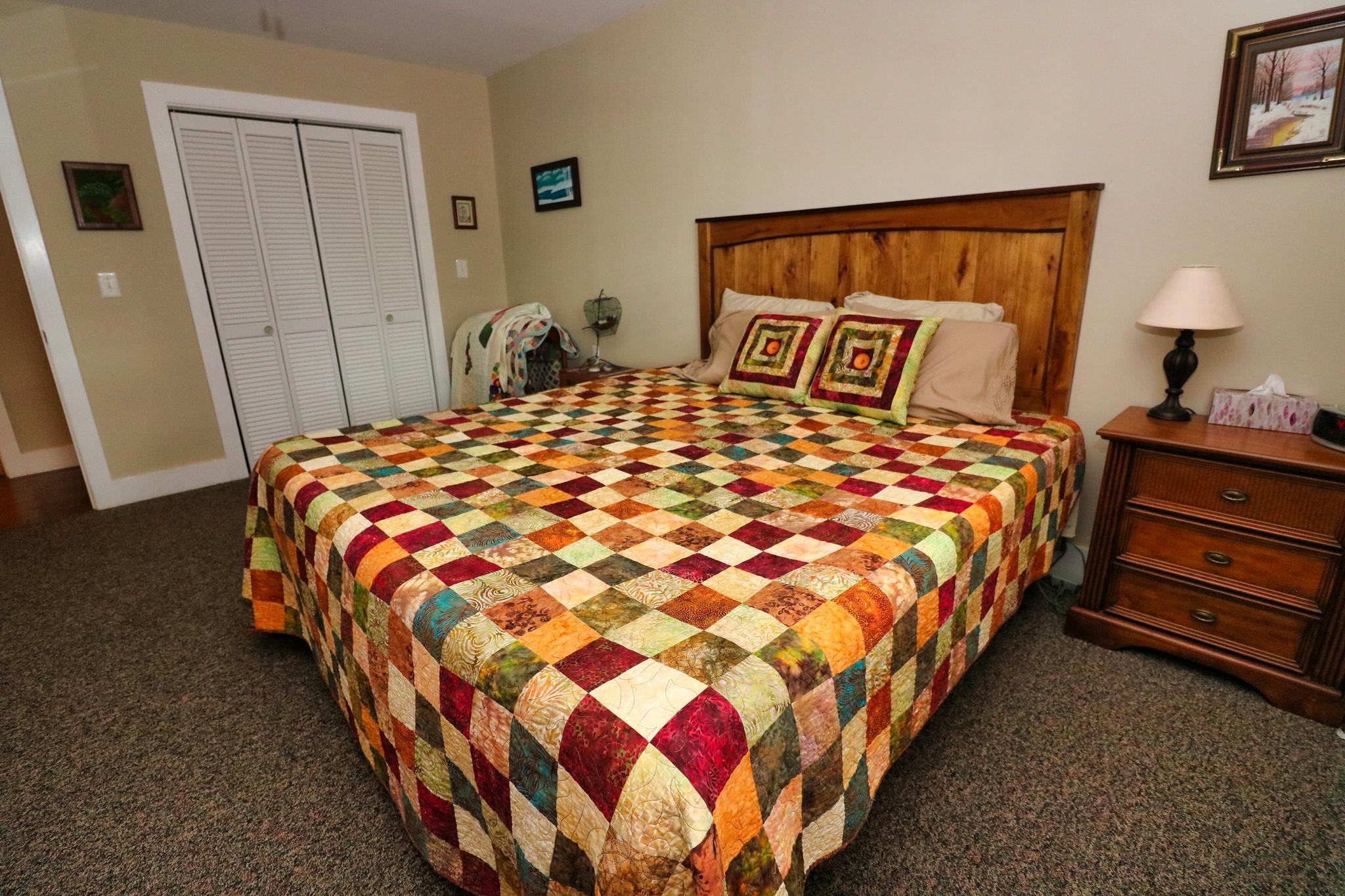 2090 Fairview Road Tellico Plains, TN 37385 - Photo 23 of 40 a bedroom with a bed and painting on the wall