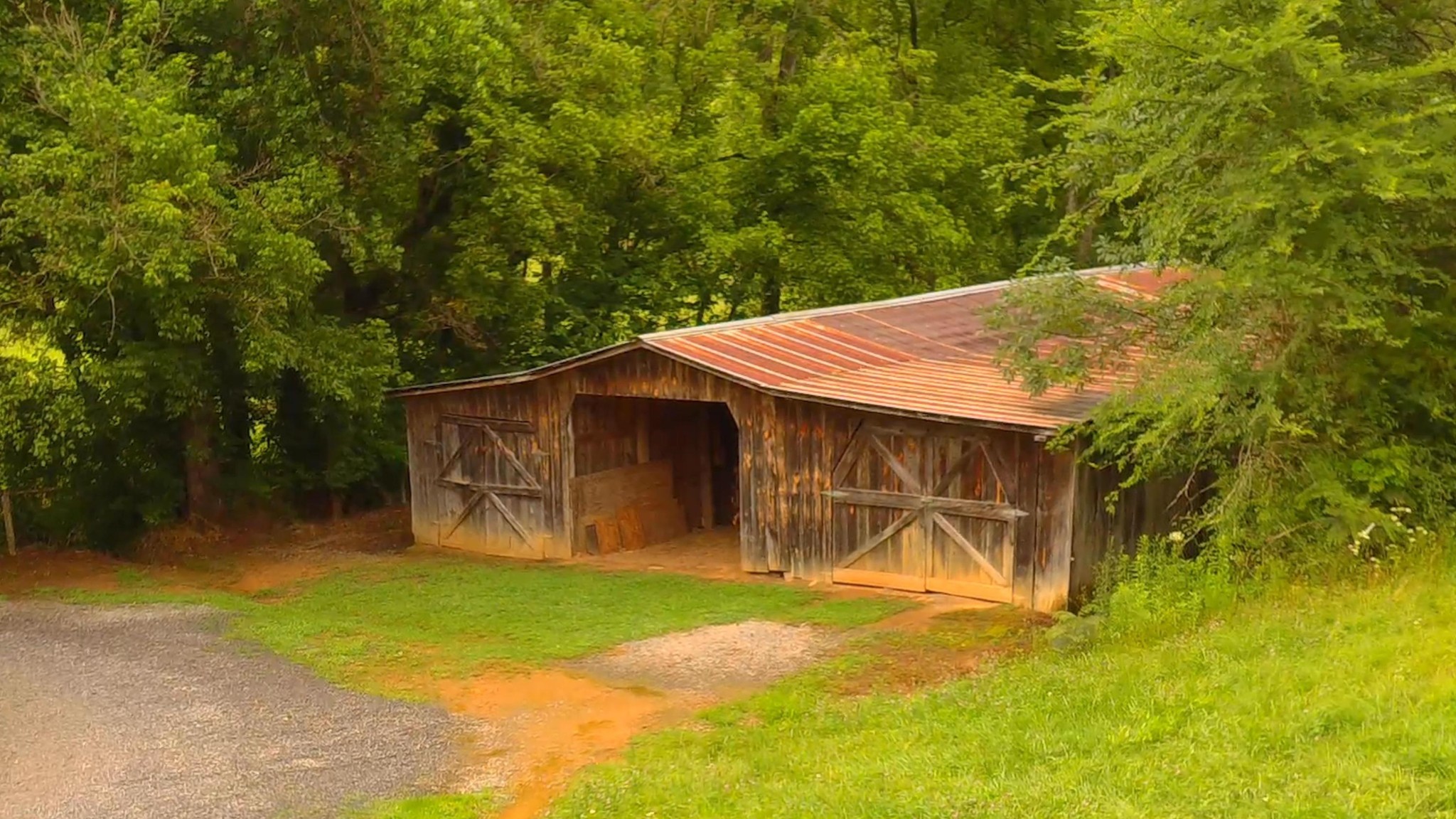2090 Fairview Road Tellico Plains, TN 37385 - Photo 35 of 40 a backyard of a house with table and chairs under an umbrella