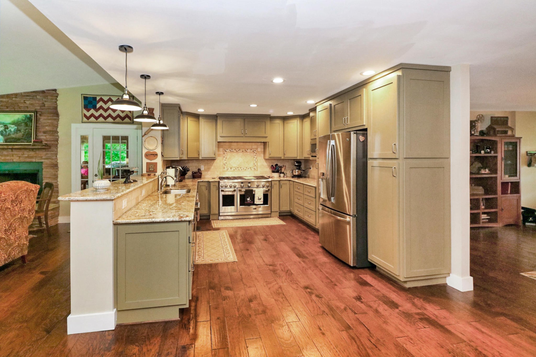 2090 Fairview Road Tellico Plains, TN 37385 - Photo 9 of 40 a kitchen with counter top space a sink wooden floor and stainless steel appliances