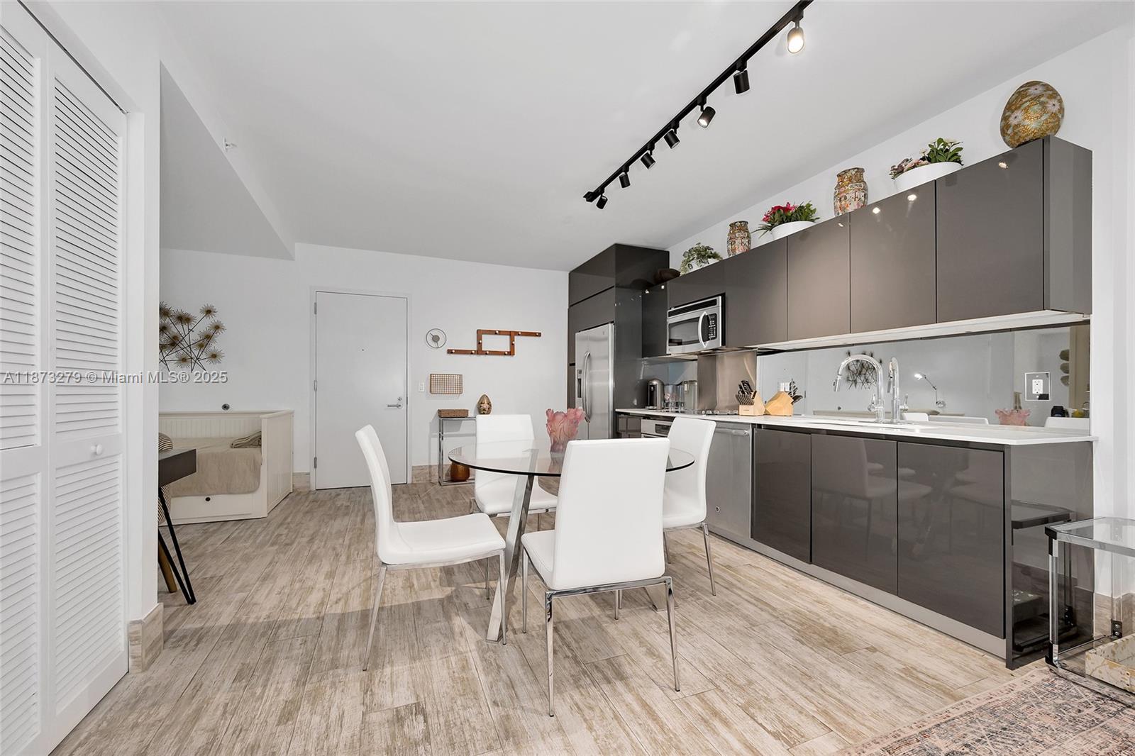 31 Southeast 6th Street, Unit 304 Miami, FL 33131 - Photo 14 of 23 a living room with furniture and wooden floor