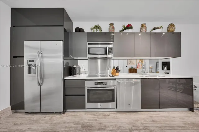 a kitchen with stainless steel appliances a refrigerator and a sink