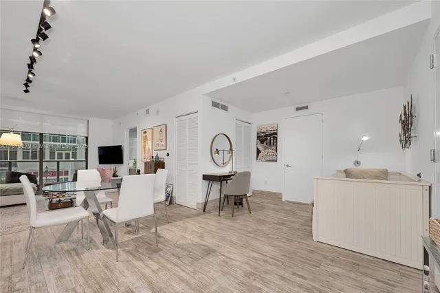 a living room with furniture a fireplace and a large window