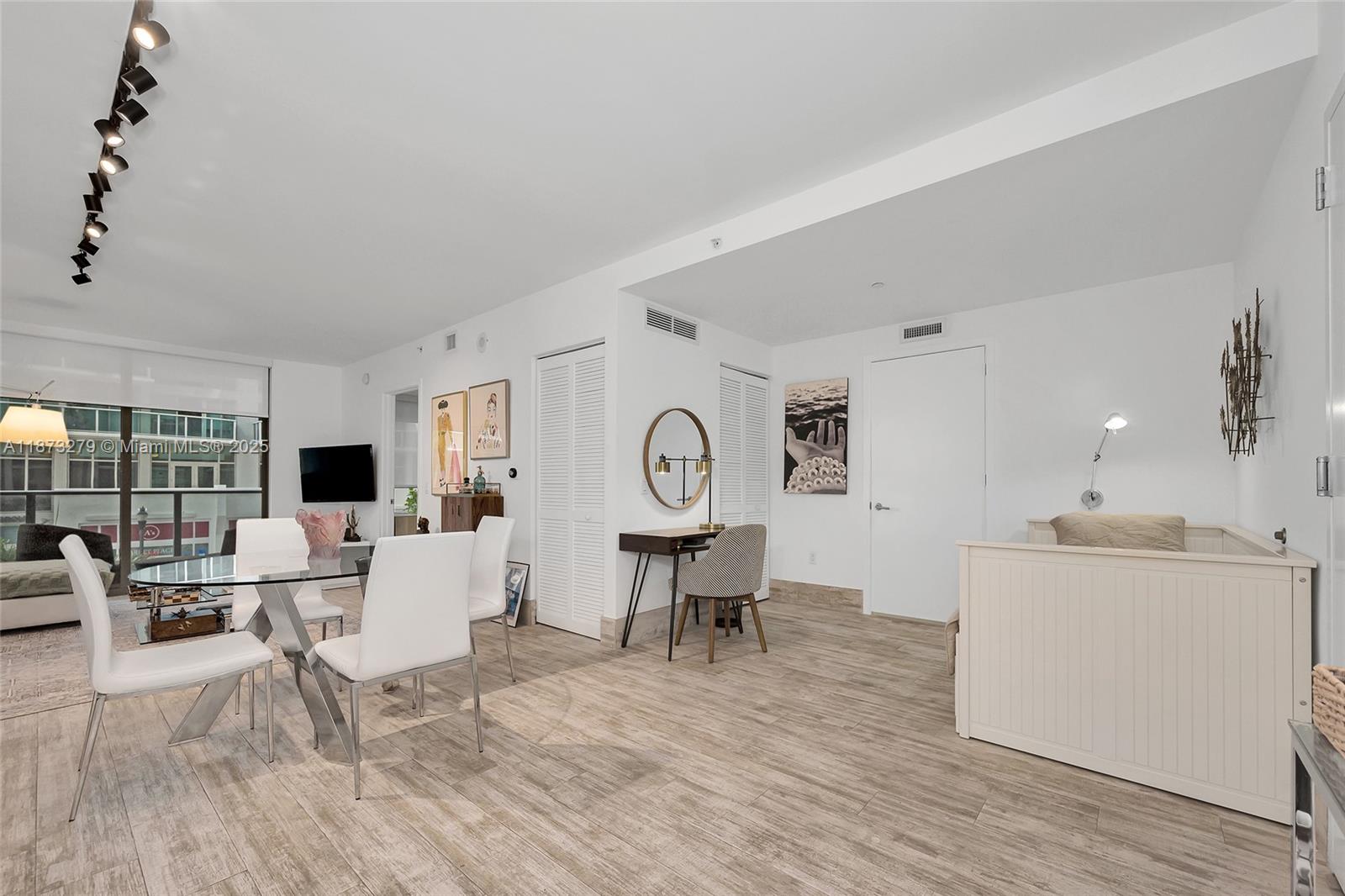 31 Southeast 6th Street, Unit 304 Miami, FL 33131 - Photo 6 of 23 a living room with furniture a fireplace and a large window