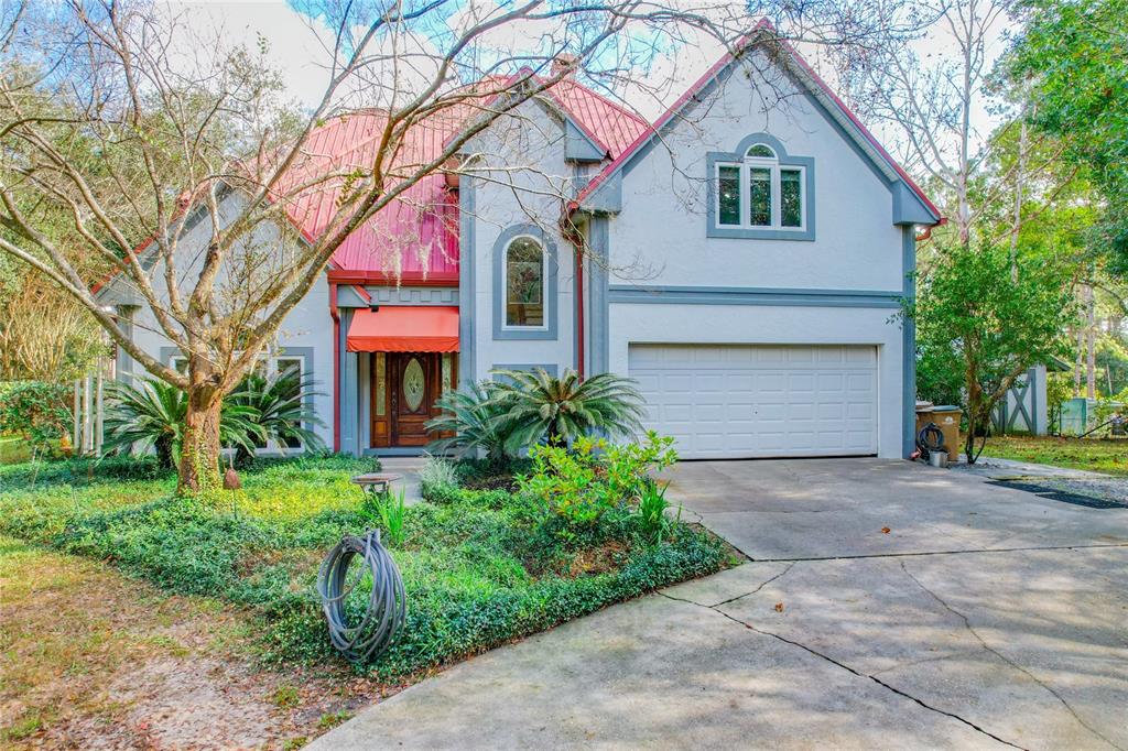 37336 Sykora Lane Eustis, FL 32736 - Photo 1 of 1 a front view of a house with garden