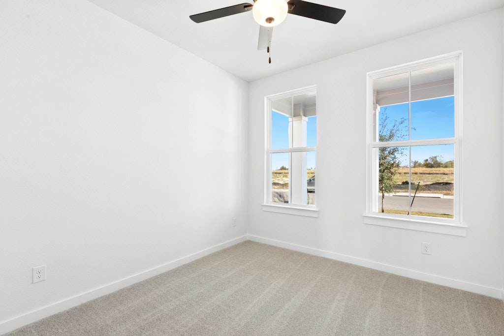 4737 Pleasant Place Round Rock, TX 78665 - Photo 11 of 30 an empty room with windows and chandelier fan