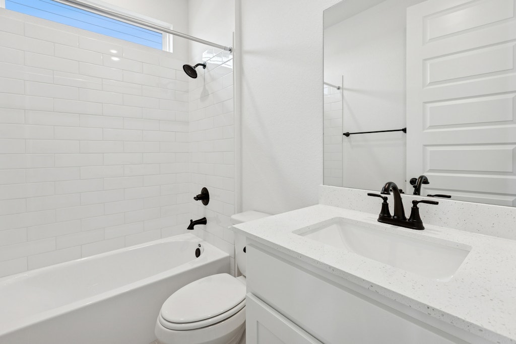 4737 Pleasant Place Round Rock, TX 78665 - Photo 13 of 30 a bathroom with a sink a toilet and a bathtub